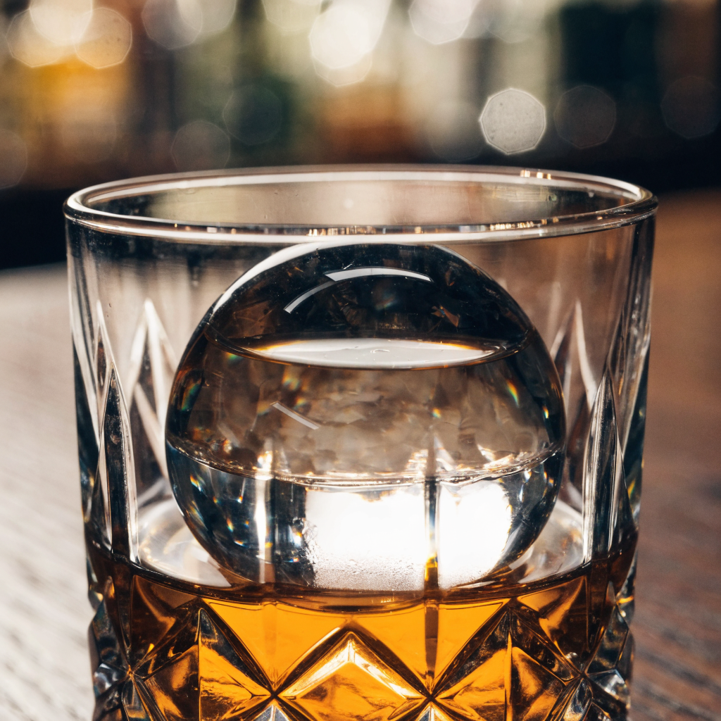 Close-up van een heldere ijsbol in een kristallen tumbler - Glazen.nl